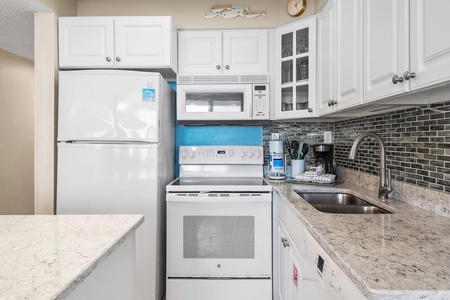 Your fully equipped kitchen makes meal prep a breeze with granite counters, modern appliances, and stylish tile backsplash.