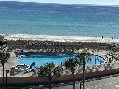 Stunning beachfront property with swimming pool overlooking pristine white sand and turquoise waters.