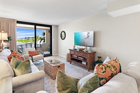 Settle into this inviting living room with coastal charm and colorful accents. Relax on plush seating while you enjoy your favorite shows, or step through to the private balcony for sunny views.