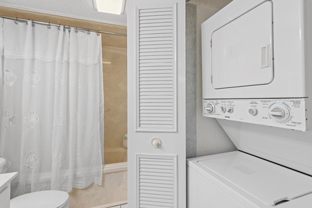 Bathroom with Tub Shower Combination and Laundry Area
