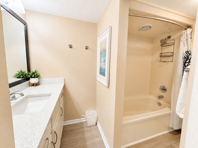 Step into your private bathroom, where a spacious tub awaits your relaxation. Fresh towels and thoughtful touches like organizers and soft linens make every moment feel just right.