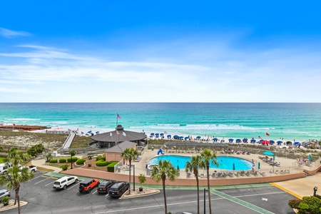 Beachfront resort with swimming pool, beach access, and stunning turquoise waters stretching to the horizon.