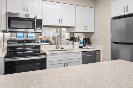 Relax in this bright oceanfront living space where coastal artwork and blue accents complement stunning sea views through your windows.