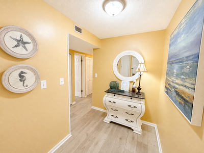 Step into your coastal retreat where charming nautical touches and warm tones welcome you home. The cheerful hallway sets a relaxed tone for your beach getaway.