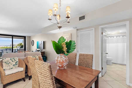 Bright, breezy coastal décor welcomes you into this open living and dining space, where natural light, tropical touches, and a peek at the sea create an instant vacation vibe.
