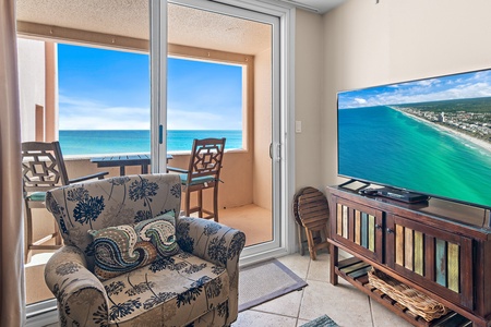 Relax in your oceanfront living room where turquoise waters stretch endlessly beyond floor-to-ceiling windows, creating the perfect backdrop for your beach getaway.
