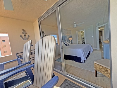 Step onto your private balcony with nautical touches and peek through sliding doors into your cozy bedroom retreat.