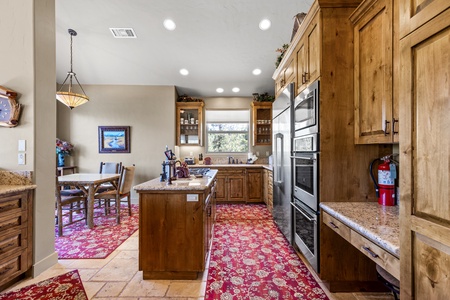 Kitchen with commercial fridge and double ovens