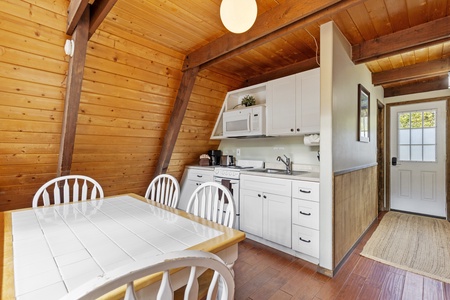 Kitchen and dining space with seating for four.