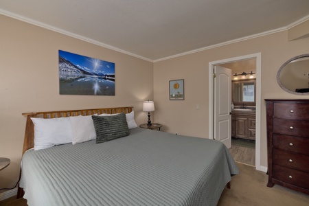 Relax in your cozy bedroom featuring a plush bed with crisp linens, warm lighting, and an en-suite bathroom just steps away for your convenience.