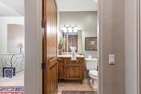 Powder room on entry level shared by living