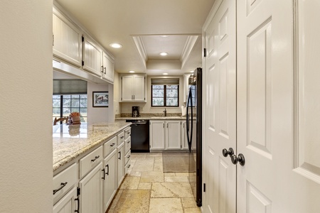 Kitchen with laundry closet to the left with washer and dryer