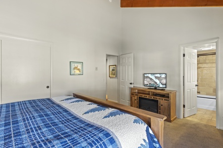 Flat screen and electric fireplace in bedroom