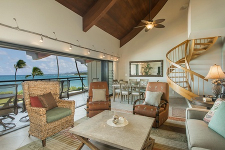 Tropical-style living room opens to the oceanfront, blending indoor comfort with breathtaking views