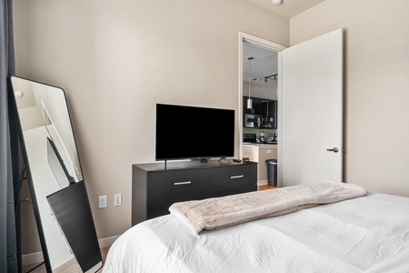 Experience a tranquil rest on a memory foam mattress in this cozy bedroom equipped with a  smart TV.