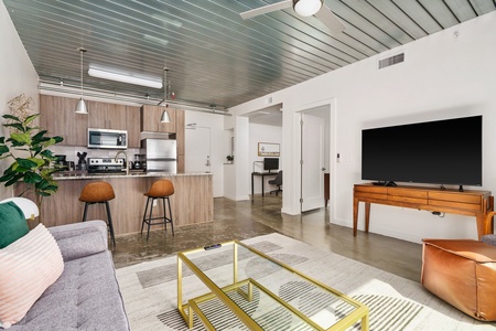 Snuggle in and relish the smart TV experience within this chic and comfy modern living area.