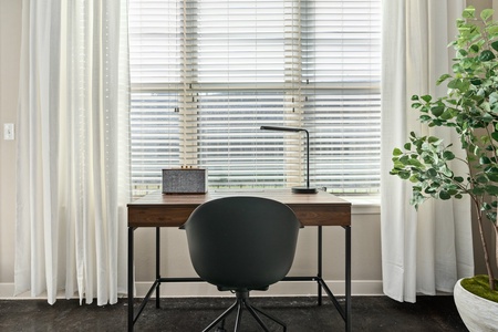Focus on your tasks in the dedicated desk area with abundant natural light.