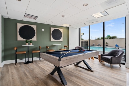 The ground floor features creative lounge areas designed for relaxation, along with a pool table to enjoy some casual play.