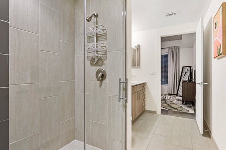 Get ready to conquer the day in the contemporary walk-in shower with stylish fixtures.