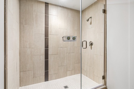 Rejuvenate in the contemporary walk-in shower with stylish fixtures.