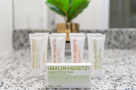 Luxuriate in complimentary toiletries by Malin + Goetz in the bathroom.