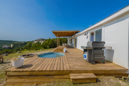 The large patio deck includes a ranch-style pool and BBQ grill