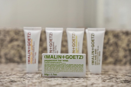 Pamper yourself with complimentary toiletries by Malin + Goetz in the bathroom.