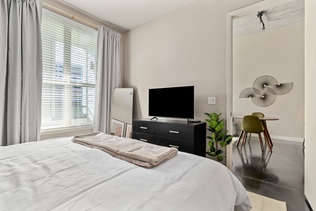 Relax into dreamland on a memory foam mattress in this snug bedroom equipped with a smart TV.
