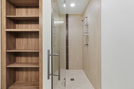 Revive in the modern walk-in shower with sleek fixtures.