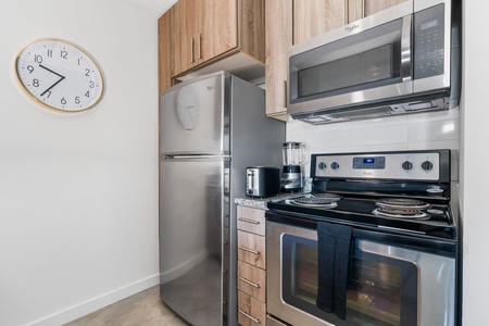 Whip up culinary delights in this modern kitchen with all the essentials.