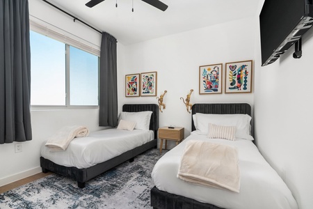 Bedroom 3: A cozy bedroom featuring comfortable twin beds, perfect for sharing.