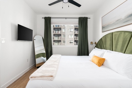 Experience a tranquil rest on a memory foam mattress in this cozy bedroom equipped with a 40' smart TV.
