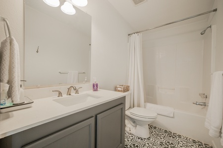 The third bathroom features a bath tub and shower