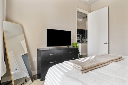 Experience a tranquil rest on a memory foam mattress in this cozy bedroom equipped with a  smart TV.
