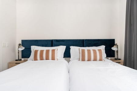 Optional Extra: One bedroom can be set up with two twin XL beds instead of a king for a nighly supplement on extended stays - please contact us for details (this is a photo from another apartment - the apartment has art above the beds))