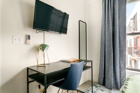 Maintain your workflow in the dedicated desk area with ample natural light.