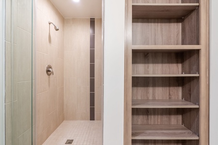 Feel invigorated in the modern walk-in shower with sleek fixtures.