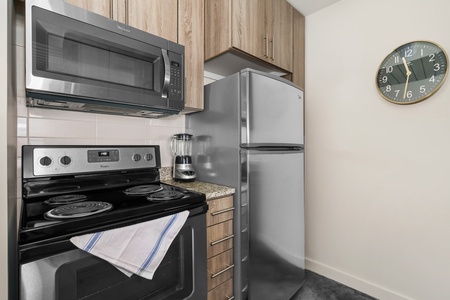 Whip up culinary delights in this modern kitchen with all the essentials.