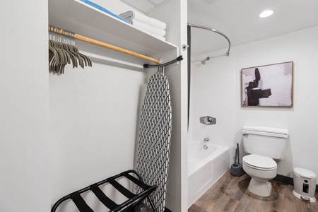 A well-stocked closet with hangers and plush towels to keep you organized and comfortable.