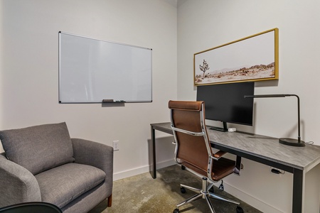 The office features an electric height-adjustable standing desk (not shown in this photo, as it's of another unit with the same layout)