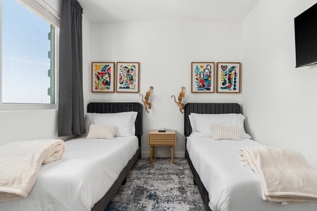 A cozy bedroom featuring comfortable twin beds, perfect for sharing.