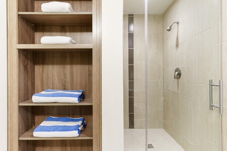 Experience a revitalizing shower in the walk-in shower with modern fixtures.