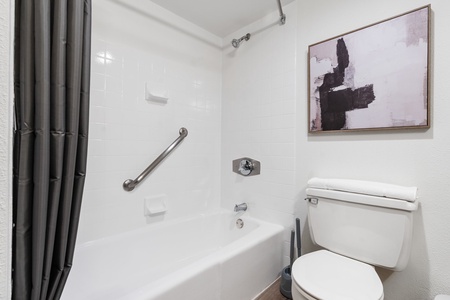 Refresh in the modern bathroom featuring a tub shower and all the essentials.
