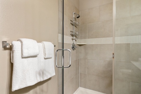 Rejuvenate in the contemporary walk-in shower with stylish fixtures.