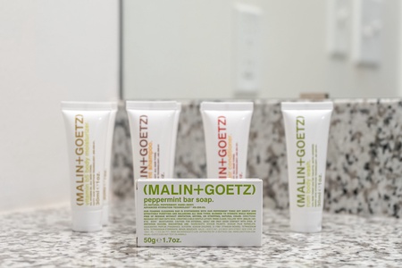 Luxuriate in complimentary toiletries by Malin + Goetz in the bathroom.