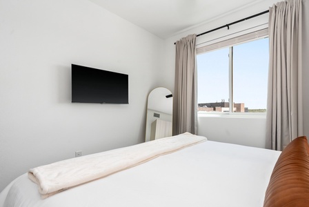 Sleep soundly on a memory foam mattress, then enjoy your favorite shows on the smart TV in this cozy space.