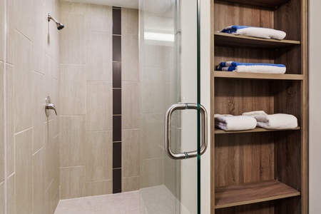 Get ready to conquer the day in the contemporary walk-in shower with stylish fixtures.