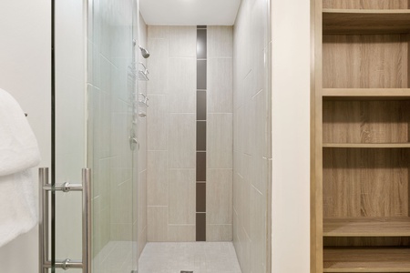 Get ready to conquer the day in the contemporary walk-in shower with stylish fixtures.