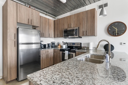 Whip up culinary delights in this modern kitchen with all the essentials.