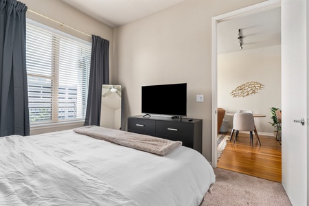 Relax into dreamland on a memory foam mattress in this snug bedroom equipped with a smart TV.